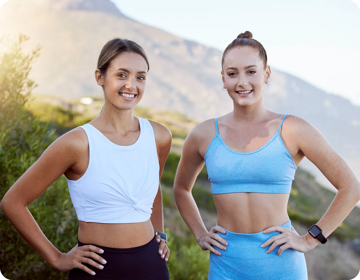 Two smiling women in workout clothes outdoors